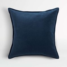 a dark blue pillow on a white background