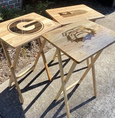 two wooden tables sitting on top of a sidewalk