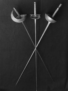 an old photo of two metal objects on a black background