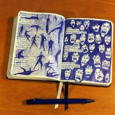 an open notebook with drawings on it next to a pen