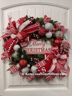 a red and white christmas wreath hanging on a door with the words merry christmas written in it