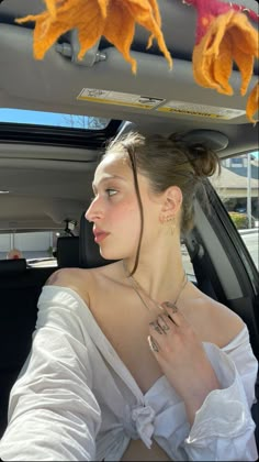 a woman sitting in the back seat of a car