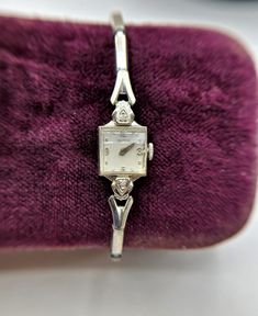 "This is a beautiful and dainty vintage Croton 10K White Gold Ladies Watch with 2 Tiny Diamond Accents. The stretch expandable band is by Kreisler 1/20 of 10K gold filled top. This is a mechanical watch, does not use batteries. It is not working and needs repair. Watch measures 1/2\" wide, Band is 6\" and expandable. Weighs 12.77 grams." Dainty Watches, Aesthetic Watches, Linda Smith, Silver Watches Women, Vintage Watches Women, Small Watch, Luxury Watch Brands, Watches Women, Magical Jewelry