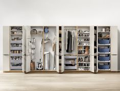 an open closet with several shelves and drawers on each side, all filled with shoes