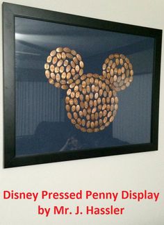 a mickey mouse made out of wine corks hanging on the side of a wall