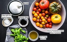 a bowl filled with lots of different types of vegetables next to some dipping sauces