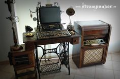 an old fashioned sewing machine sitting on top of a wooden table next to a computer