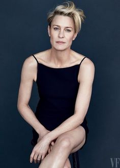 a woman sitting on top of a chair in front of a black background with the caption vanity fair