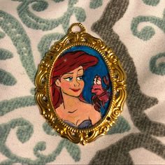 the little mermaid is depicted in an ornate frame