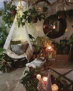 a room with plants and candles on the floor