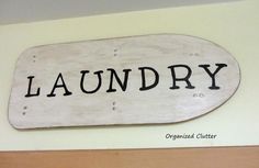 a wooden sign that says laundry hanging on the wall