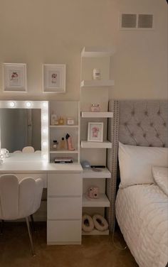 a bedroom with a bed, desk and mirror