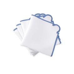 three white and blue napkins on top of each other, one with a scalloped edge