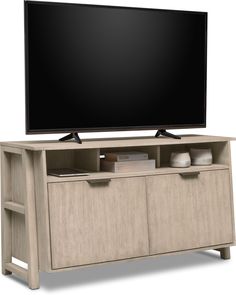 an entertainment center with a flat screen tv mounted on it's side and drawers