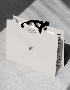 a white paper bag sitting on the ground