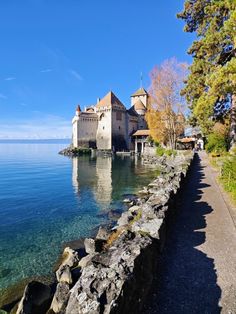 an old castle sitting on top of a cliff next to the ocean