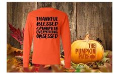 an orange shirt with the words pumpkin patch on it and a pumpkin sitting next to it