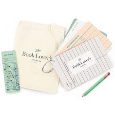 the book lover's journal is next to some books and pencils on a white surface