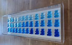 a display case with blue glass chess pieces on the front and back sides, all in clear acrylic