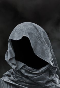 a hooded person with a hood on in front of a dark cloud filled sky,