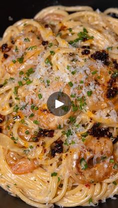 pasta with shrimp and parmesan cheese in a skillet on the stove top