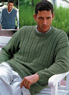 a man sitting on a white chair wearing a green knitted sweater and looking at the camera