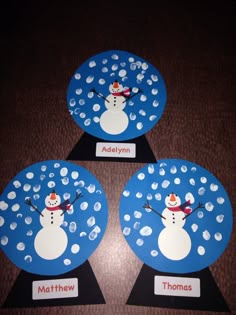 three snowmen are on top of each other in the middle of two circles with name tags