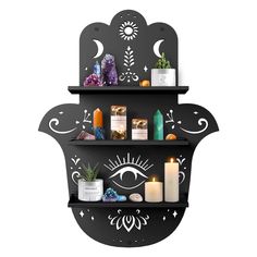 two shelves that have candles and other items on them