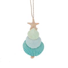 an ornament shaped like a shell with a starfish hanging from it's side