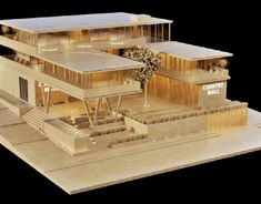 an architectural model of a building with lights on