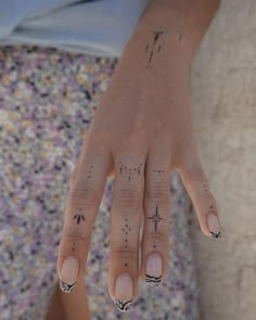 a woman's hand with black and white designs on it