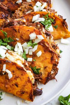 a white plate topped with food covered in toppings