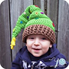 a young boy wearing a crocheted hat with buttons