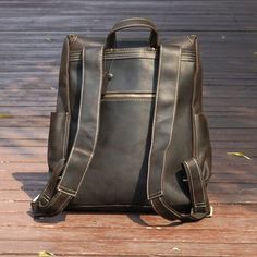 Elevate your daily commute with our Vintage Leather Backpack, seamlessly combining timeless style with practical functionality.   Crafted from heavy duty genuine leather, this rucksack not only exudes a vintage charm but also ensures lasting durability. The spacious interior is thoughtfully designed to accommodate your everyday essentials, featuring a dedicated laptop sleeve (fits laptop up to 15. 6''), wide shoulder straps for comfort, convenient side pockets, and elegant brass metal parts. Outer 100% vegetable tanned, genuine saddle (cowhide) leather, which develops worn look patina. Inner 30% cotton, 70% polyester, cloth lined. Use professional leather caring kit. Patina is the unique character of the saddle leather. Rub at the patina with your fingers to lighten it.  Adjustable wide sh