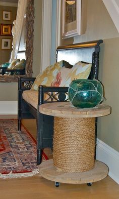 a living room filled with furniture next to a mirror and rug on top of a hard wood floor