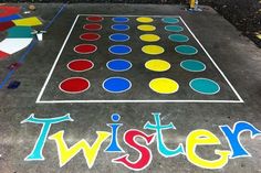 a chalk board that says twister painted on the ground with colored circles around it