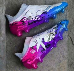 the adidas shoes have been painted with purple and blue paint on it's soles