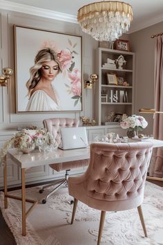 a desk with a laptop on it in front of a painting and chandelier