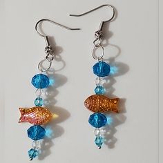 Handmade By Me In Birmingham Alabama, These Are One Of Three Designs I Have Made Up Right Now In These, You May However Choose Your Own Style, Colors, Hooks Etc. See The Last Few Photos Of The Other Colors, These Are The 18k Gold Plated Filigree Hooks With Blue And Clear Bubbles With Orange Murano Glass Lampwork Fish Bead. All Beads Used Here Are Glass. Very High End Swarovski Crystal, Art Glass, And Glass All Used In The Designs. Leverbacks Are Available As Well As Hoops Too. See Other Options. Blue Fish-shaped Earrings For Gift, Blue Fish Hook Earrings For Gift, Gift Blue Fish Hook Earrings, Goldfish Earrings, Lampwork Bead Jewelry, Marquise Earrings, Bubble Earrings, Crystal Heart Earrings, Lampwork Earring