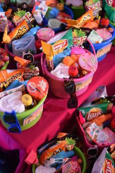 many colorful baskets filled with candy on top of a table