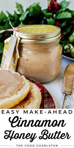 homemade cinnamon honey butter in a mason jar on a plate with a spoon and holly