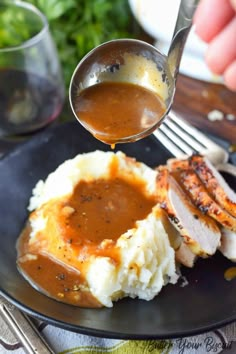 a plate with mashed potatoes, gravy and meat