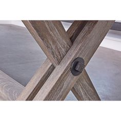 a close up of a wooden table with an iron ring on it's end