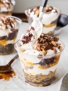 three desserts in plastic cups on a table