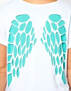 the back of a person wearing a white shirt with blue angel wings on it's chest