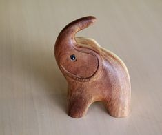 a small wooden elephant sitting on top of a table