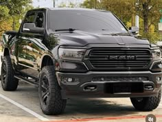 a black ram truck parked in a parking lot