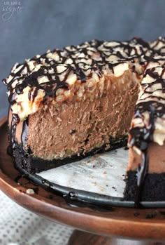 a chocolate cheesecake on a plate with one slice missing