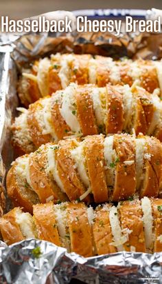 several cheesy bread rolls in foil lined up on a table with text overlay