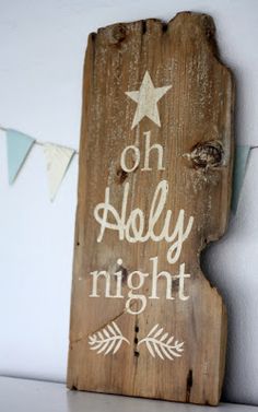 a wooden sign with the words on holly night written in white paint and an arrow